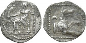 LYCAONIA. Laranda. Obol (Circa 324/3 BC). 

Obv: Baal seated left on throne, holding grain ear, grape bunch and sceptre.
Rev: Forepart of wolf righ...