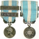 FRANCE
Colonial Medal, instituted in 1893
Breast Badge, 27 mm, silvered Bronze, original suspension ring and ribbon with "Extreme Orient, Tunisie" c...
