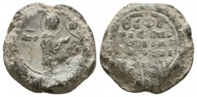 Byzantine lead seal of N. officer 
(11th cent.)
Obverse: Mother of God standing in profile to right in praying posture before manus Dei (blessing hand...