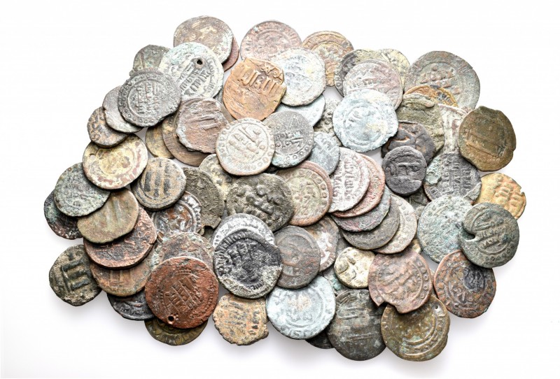 A lot containing 80 bronze coins. All: Islamic. About fine to about very fine. L...