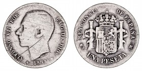 La Peseta
Alfonso XII
Peseta. AR. 1884 MSM. 4.76g. Cal.23. Estrellas no visibles y rayas. Rara. (BC-).