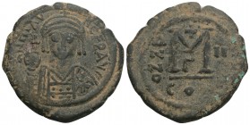 Byzantine
Justinian I Æ 40 Nummi. Constantinople 12.6gr 30.6mm
Helmeted and cuirassed bust facing, holding globus cruciger and shield; cross in right ...