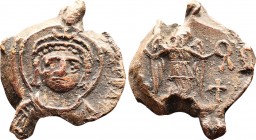 Byzantine Lead Seal Lustinianus I (527-565)

Obverse, bust of Lustinian I, frontal, with halo, without beard. Diadem with a helmet and trifolium and...