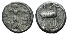Bruttium, Kaulonia, c. 475-425 BC. AR Drachm (12mm, 2.23g, 9h). Apollo advancing r., holding branch; small daimon running r. on Apollo's l. arm; to r....
