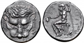 Bruttium, Rhegion AR Tetradrachm. Circa 435-425 BC. Facing lion's head; to right, hare running upwards / Male figure (Iokastos, or Aristaios) seated t...