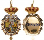 SPAIN
An insignia of Member of the Senate
A Gold insignia of Member of the Senate, 49x40 mm, oval, with the 
coat-of-arms of Spain, within blue-fil...