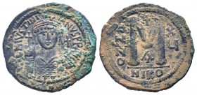 JUSTINIAN I. 527-565 AD. Nicomedia mint.AE Follis. DN IVSTINIANVS PP AVG, helmeted, cuirassed bust facing, holding cross on globe and shield with hors...