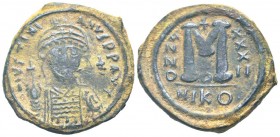 JUSTINIAN I.527-565 AD.Nicomedia mint.AE Follis.D N IVSTINIANVS P P AVG; Helmeted and cuirassed bust facing, holding globus cruciger and shield; cross...