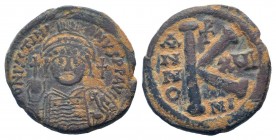 JUSTINIAN I.527-565 AD. Nicomedia mint.AE Half-follis. DN IVSTINIANVS PP AVG, helmeted, cuirassed bust facing, holding cross on globe and shield with ...