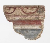 DECORAZIONE IN STUCCO DIPINTO
 I - II secolo d.C.; alt. cm 7; largh. cm 6; plexiglass cm 13 x 11; PROVENIENZA Collezione privata, Roma.