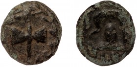 Macedonia, AE11 quarter unit, ca 323-317 BC. . 
bipennis within wreath 
B-[A] (?) to left and right of Macedonian helmet with earflaps. 
Apparently un...