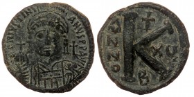Justinian I (527-565), AE28 Half-follis, Constantinople. 
DN IVSTINIANVS PP AVG, helmeted, cuirassed bust facing, holding cross on globe and shield; c...