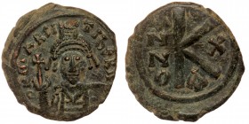 Maurice Tiberius. (582-602) AE21 half follis Constantinople mint, year 10 = AD 591/592. 
D N MAVR TIBER PP AV, helmeted and cuirassed bust facing, hol...