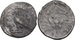Sicily. Akragas. AR Litra, circa 450-440 BC. Obv. Sea eagle standing left, with closed wings, on Ionic capital. Rev. Crab; ΛI (mark of value) below. H...