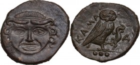 Sicily. Kamarina. AE Tetras or Trionkion, c. 420-405 BC. Obv. Gorgoneion facing, tongue slightly protruding. Rev. KAMA. Owl standing right, head facin...