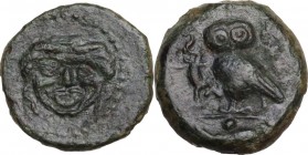 Sicily. Kamarina. AE Onkia. Circa 420-405 BC. Obv. Gorgoneion. Rev. KAMA. Owl standing left, head facing, holding lizard in talon; pellet in exergue. ...