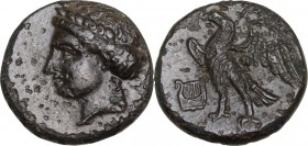 Greek Asia. Caria, Halikarnassos. AE 12 mm. Mid 4th-3rd centuries BC. Obv. Laureate head of Apollo left. Rev. Eagle standing left, wings displayed; ly...