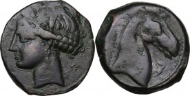 Punic Sardinia. AE 20 mm. Circa 300-264 BC. Uncertain mint. D/ Wreathed head of Kore left, wearing triple-pendant earring; behind, crescent and globe....