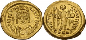 Justinian I (527-565). AV Solidus, Constantinople mint. Obv. DN IVSTINIANVS PP AVG. Helmeted and cuirassed bust facing, holding globus cruciger and sh...