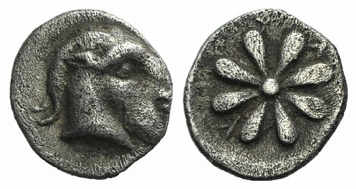 Aeolis, Kyme, 4th century BC. AR Obol (8mm, 0.63g). Head of goat r. R/ Floral pa...