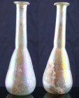 Romain - Fiole en verre irisé - 100 av / 100 ap. J.-C.
Grande fiole à irisation dorée, à panse en forme de poire et col long. 125 mm.
