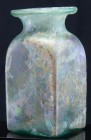 Romain - Bouteille en verre irisé - 100 / 300 ap. J.-C.
Belle bouteille en verre irisé à panse carrée et col évasé. Belle irisation . 118*55 mm....