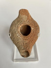 A Samaritan-Jewish Beit-Shean Oil Lamp. Ca. 5th-6th Century CE. Composed of an elongated body, a short nozzle and handle, this lamp is an excellent ex...