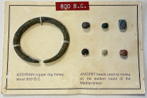 ANCIENT: ASSYRIA: AE ring, ca. 800 BC, 58 x 49mm, plus 6 ancient beads used as money in the Levant, secured on display card, Fine, ex Charles Opitz Co...