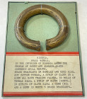 NIGERIA: brass bangle, 84mm (3 1/4") in diameter, decorated at side ends, set on interesting old information card, VF, ex Charles Opitz Collection. 
...