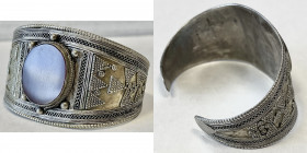 NORTH AFRICA: AR arm ring (24.03g), 62 x 40mm, decorated with an oval carnelian disc and intricate patterns all around, made in fine silver by the Ber...
