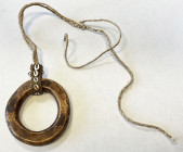 WESTERN NEW GUINEA: shell ring money (136.45g), 88 x 82mm, attached with woven band with six small shells and long string, a very old specimen from th...