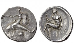Greek Coins 
 Calabria, Tarentum 
 Nomos circa 425-415, AR 8.20 g. Naked Phalantus seated on dolphin l., holding shield in l. hand and extending r. ...