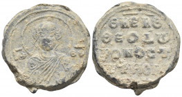 BYZANTINE SEALS. Theodoros, imperial ostiarios, Circa 10th-11th century. Seal or Bulla (Lead, 23 mm, 12.57 g, 12 h). Facing bust of the Theotokos, rai...
