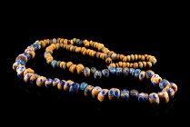 Celtic Mosaic Eye Bead Necklace, c. 6th-5st century BC. Spherical glass beads in blue, yellow and green with concentric ring detail. Modern wire.