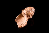Roman Terracotta Child Bust, c. 1st-3rd century AD (5.6cm). Draped bust of child with curly hair. Broken, nice style.