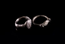 Lot of 2 Roman Bronze Finger Rings, c. 3rd-5th century AD (2.2cm). Bezels engraved with floral and circle patterns. Intact.
