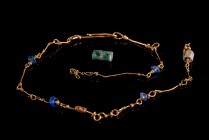 Roman Bracelet made of a golden chain with differently shaped beads made of nacre, red and blue glass, c. 3rd century AD. Partially intact.