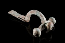 Roman Bronze Crossbow Fibula, 3rd-4th century AD (9.8cm). Heavy brooch with three knobs, long foot decorated with pellet-in-circle designs. Pin missin...