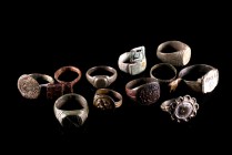 Roman and Byzantine. Lot of Eleven bronze finger rings: thee of them with inscriptions, plus three with simple geometric designs and one with a florea...