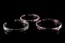 Lot of 3 Byzantine Bronze Bracelets with punched and chip carved decor. c. 5th - 6th century A.D. Green patina, intact.