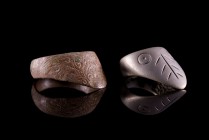 Two Byzantine-Medieval Bronze Finger Rings, c. 13th-14th century (3.2-3.8cm). Archer's rings with D-section hoop and triangular extension with incised...