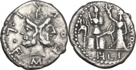 M. Furius L. f. Philus. AR Denarius, 119 BC. Obv. Head of Janus, laureate. Rev. Roma standing left, holding sceptre and crowning trophy flanked by car...