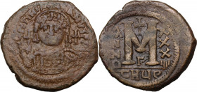 Justinian I (527-565). AE Follis. Theoupolis (Antioch) mint. Dated RY 34. Obv. Bust facing, helmeted, cuirassed, holding globus cruciger and shield. R...