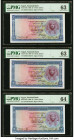 Egypt National Bank of Egypt 1 Pound 1960 Pick 30d Three Examples PMG Choice Uncirculated 63 (2); Choice Uncirculated 64. Minor stains on one examples...