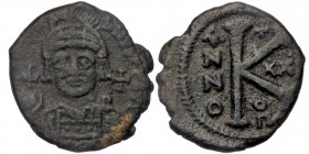 Justinian I AE 20 Nummi. Theoupolis (Antioch)
Helmeted and cuirassed bust facing, holding globus cruciger and shield; cross in right field
Rev: Large ...