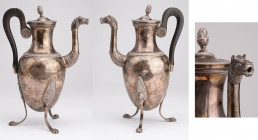 FRANCE
Large tripod silver jug 
A large tripod silver jug (cofee pot), beak with dragon head and chiseled melted pattern, blackened wood handle (res...