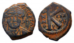 JUSTIN II.565-578 AD.Antioch ( Theoupolis ) mint.AE Half Follis. Helmeted and cuirassed bust facing, holding Victory on globe and shield; cross to rig...