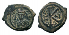 MAURICE TIBERIUS.582-602 AD.Constantinople mint.AE Half follis. D N mAVRICI TIbER P P AV; helmeted and cuirassed bust of Maurice Tiberius facing holdi...