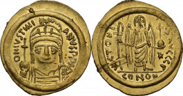 Justinian I (527-565). AV Solidus, Ravenna mint, 552-565 AD. Obv. DN IVSTINIANVS PP A. Helmeted and cuirassed bust facing, holding globus cruciger and...