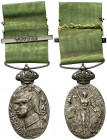1915. Alfonso XIII. Campaña de África. Medalla. (Pérez Guerra 816b var). Con corona, cinta y pasador con TETUÁN inscrito. Bella. Plata. 19,22 g. 40x28...
